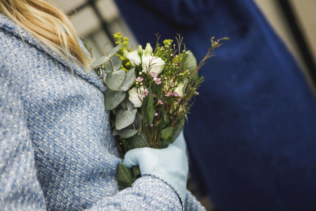 Close-up of wedding rings and floral arrangement at Irish wedding.